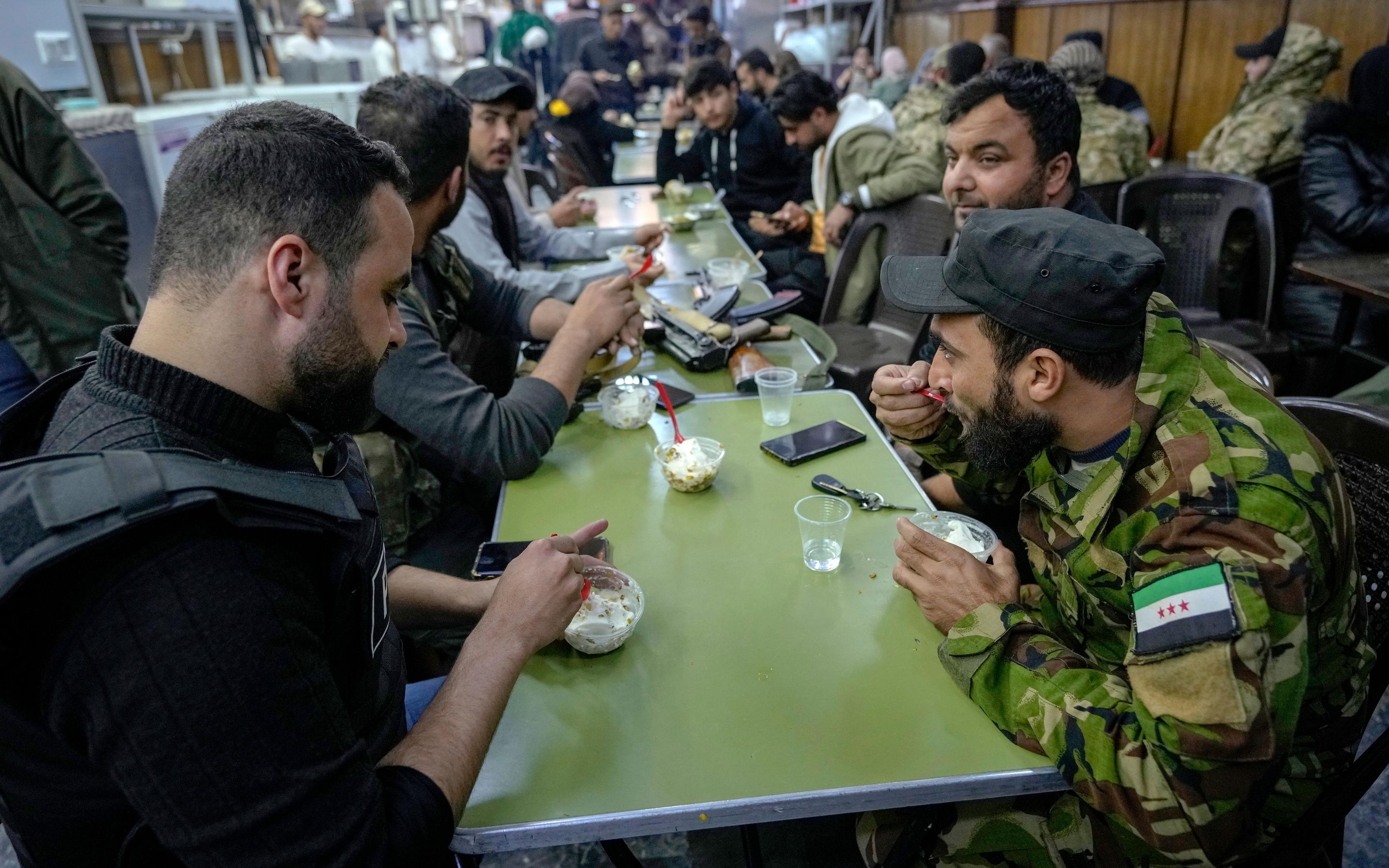 Fighters in a cafe in the Syrian capital