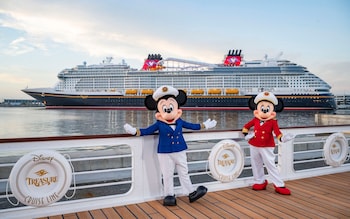 Mickey and Minnie in front of Disney Cruise Line's new ship, the Disney Treasure in Port Canaveral
